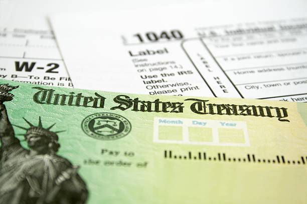 tax refund check with w 2 and 1040 u.s. individual income tax return forms